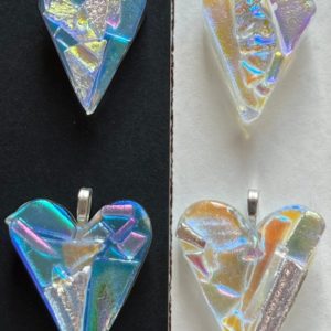 "Collection of four iridescent heart pendants with geometric patterns on contrasting backgrounds"