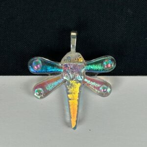 Dragonfly dichroic glass pendant featuring transparent rainbow-shifting wings and golden body on black background