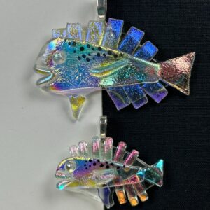 Two Mai Mai dichroic glass pendants, large and small sizes, displayed on split black and white background showing iridescent blues and pinks