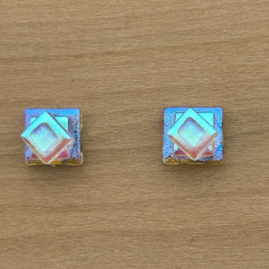 Aqua gold glass Totem post earrings with layered square design and shimmering dichroic finish on wood background