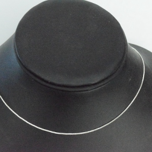 Sterling silver box chain necklace with sleek 1mm design on display bust