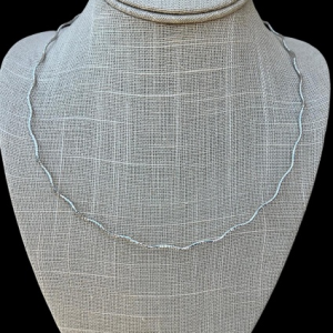 20 inch sterling silver rhodium plated wavy chain necklace with 1.5mm thickness on gray jewelry bust