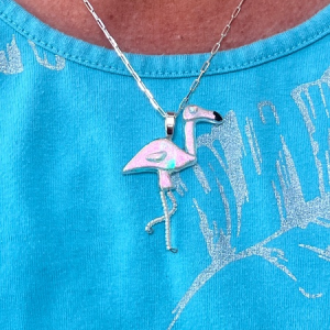 Pink dichroic flamingo pendant worn on silver chain